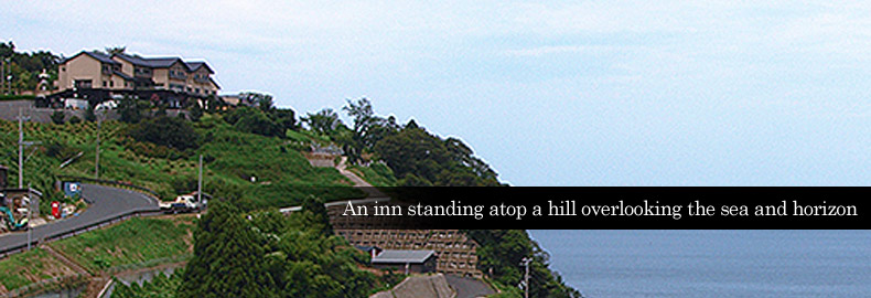 An inn standing atop a hill overlooking the sea and horizon